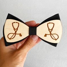 Doctor bow tie Medical student gift for men Wooden bowtie Size Bow tie 4,5x2,5 inch (11,5x6,5 cm) Neck 14 х 20,5 inch (35,5 - 52 cm) Size Kids 3,5 x 1,5 inches ( 9 x 3,8 cm) Neck regulated. The bow tie is packaged in a wonderful kraft or wood box with a beautiful bow. You will have a perfect and unique gift! The bow tie is handmade and created with huge love! You have a nice opportunity to order this cool doctor bow tie and present it as a special gift for your friend! White Bow Suit And Tie Accessories As Gift, White Suit And Tie Accessories With Bow For Gifts, White Suit And Tie Accessories With Bow As Gift, Father's Day Gift Bow Tie And Suit Accessories, Adjustable Bow Tie For Gifts, Brown Bow Tie For Father's Day Gift, Adjustable Bow Tie For Suit As Gift, White Bow Tie Suit Accessories For Gift, Suit And Tie Accessories With Butterfly Knot For Gifts