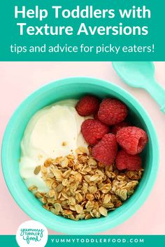 a bowl filled with granola, yogurt and raspberries