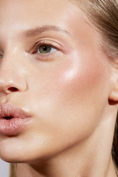 a close up of a woman's face with light makeup