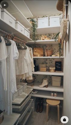 an organized closet with white shelves and drawers