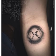 a black and white photo of a person's arm with a tattoo on it