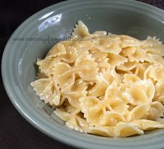 a close up of a plate of food with pasta in it on a table cloth