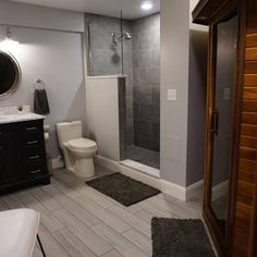 a bathroom with a toilet, shower and sink