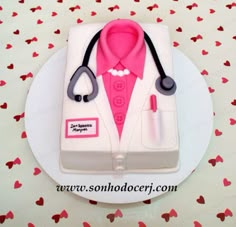 a cake with a doctor's coat and stethoscope on it