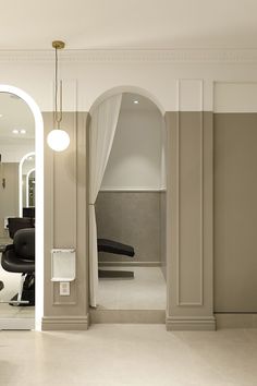 the interior of a salon with chairs and mirrors