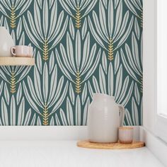 a white vase sitting on top of a counter next to a wallpapered wall