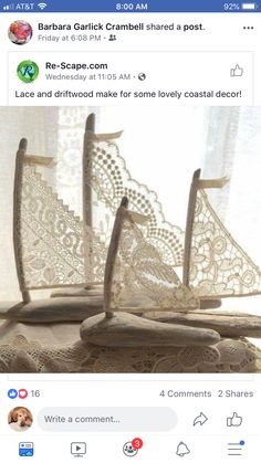 two wooden boats sitting on top of a table next to a window covered in lace