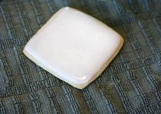 a white square object sitting on top of a bed