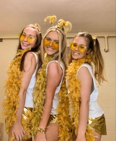 three girls in yellow and gold costumes posing for the camera