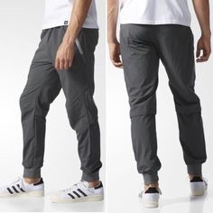 The Adidas Sp Luxe Woven Pants In Grey Elasticized Waistband With Drawstring Front Zip Pockets Reflective Logo On Left Leg Solid Colorway Slim Fit Machine Wash Cold 100% Nylon Adidas Relaxed Fit Casual Sweatpants, Casual Adidas Sports Bottoms, Adidas Casual Sports Bottoms, Adidas Casual Joggers With Pockets, Adidas Casual Relaxed Fit Pants, Casual Adidas Sweatpants With Pockets, Casual Adidas Relaxed Fit Pants, Casual Relaxed Fit Adidas Pants, Adidas Relaxed Fit Cotton Pants