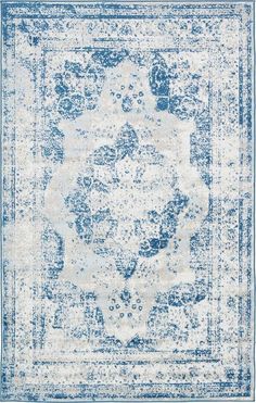 a blue and white rug with an ornate design on the bottom, in front of a white background