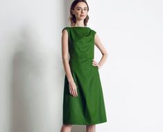 This dress is about how to draw attention to yourself and stay within the framework of the dress code. A rare skill that you definitely possess. Features of the model:  * made of quality cotton * cotton lining * trapeze skirt * below the knee length * short sleeve * boat neckline * zipper on the back THIS DRESS IS ALSO AVAILABLE IN OTHER FABRIC:  https://www.etsy.com/listing/776316097/linen-dress-blue-dress-office-dress?ref=shop_home_active_1 IMPORTANT NOTICE: Please agree with us your size before making an order. MEASUREMENT CHART: 6 (USA) / 36(EU) / 42 (UA) - 33"/26"/35" 8 (USA) / 38(EU) / 44 (UA) - 34,5"/28"/36,5" 10 (USA) / 40(EU) / 46 (UA) - 36"/29"/38" 12 (USA) / 42(EU) / 48 (UA) - 38"/31"/39" 14 (USA) / 44(EU) / 50 (UA) - 39,5"/32"/41" 16 (USA) / 46(EU) / 52 (UA) - 42"/34"/44" MODEL Green Cotton Midi-length Sleeveless Dress, Green Cotton Midi Length Sleeveless Dress, Green Cotton Sleeveless Midi Dress, Green A-line Midi Dress, Green A-line Cotton Midi Dress, Fitted Green Knee-length Asymmetrical Dress, Green A-line Midi Dress For Work, Asymmetrical Cotton Dress For Work, Asymmetrical Cotton Work Dress