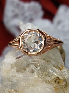 a close up of a ring on top of a rock