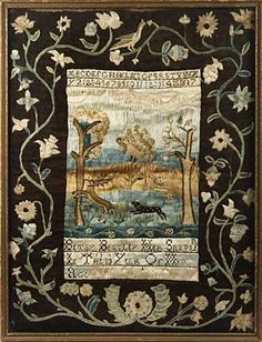 an embroidered wall hanging with flowers and animals on it's border, in a gold frame