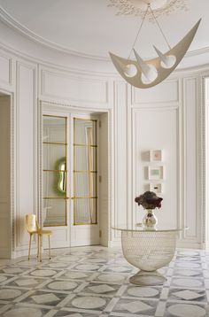 an elegant dining room with white walls and flooring