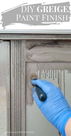 a person in blue gloves painting a wooden door with white paint and the words diy greige paint finish on it