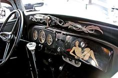 the interior of an old fashioned car is painted black and white with designs on it