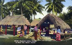 an old postcard shows people standing around huts with thatched roofs and palm trees in the background