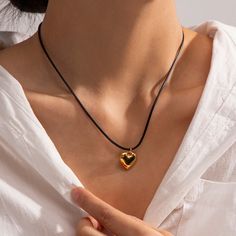 ✦Take on any adventure with our Black Cord Necklace Silver & Gold! With its edgy and cool design, this friendship necklace features a heart pendant made of surgical steel, perfect for those who love taking risks. Elevate your style with the mix of silver and gold on the black cord. ----------- DESCRIPTIONS ----------- - Size(Length): 47.5cm - Materials: 18K Gold Plated, Stainless Steel, Cord - SKU: JDN009 Black Casual Necklace With Adjustable Cord, Valentine's Day Heart Pendant Necklace With Adjustable Cord, Black Adjustable Heart Pendant Necklace, Silver Heart Necklace Black Cord, Elegant Heart-shaped Necklace With Adjustable Cord, Heart Pendant Necklace Silver, Taking Risks, Black Cord Necklace, Friendship Necklace