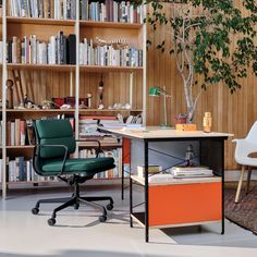 a chair and desk in front of a bookshelf