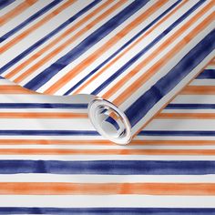 an orange, blue and white striped wallpaper with watercolor stripes on it's surface