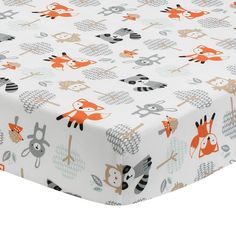 an image of a baby bed sheet with animals on it and trees in the background