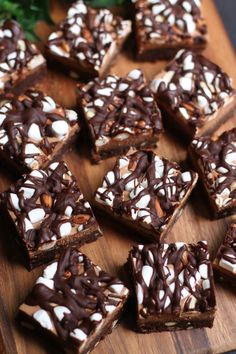 chocolate and marshmallow squares are arranged on a cutting board