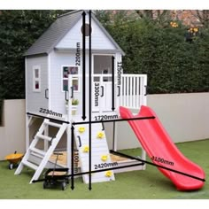 a small white house with a red slide next to it and measurements for the roof