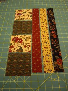 several strips of fabric laid out on a cutting board