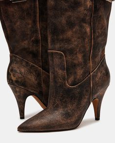 Expertly crafted, the BADDIE boot is both edgy and practical. Made with a pointed toe and buckle detail, these over-the-knee heeled boots offer a unique touch to any outfit. Elevate your style with these statement boots. 3.5 inch heel height Size 6 measurements: 16.5 inch shaft circumference, 22 inch shaft height Size 8 measurements: 17.25 inch shaft circumference, 22.5 inch shaft height Size 10 measurements: 18 inch shaft circumference, 23 inch shaft height Leather upper material Vegan leather Vintage Pointed Toe Mid-calf Boots For Fall, Chic Moto Boots With Reinforced Heel And Pointed Toe, Chic Moto Boots With Pointed Toe, Fall Knee-high Boots With Pointed Toe, Chic Wide Calf Heeled Boots With Snip Toe, Chic Snip Toe Knee-high Boots For Fall, Edgy Knee-high Heeled Boots For Work, Fall Vintage Heeled Boots With Pointed Toe, Chic Winter Knee-high Boots With Snip Toe