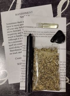 an assortment of herbs and spices on top of a piece of paper next to a pair of scissors