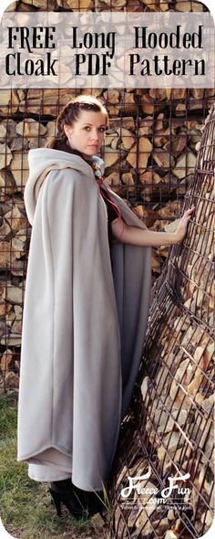 a woman is standing next to a pile of logs wearing a cape and holding a microphone