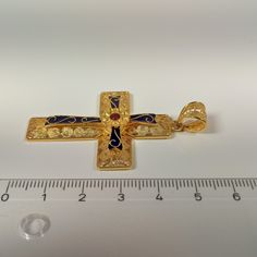 Byzantine style Cross made of 18 ct. solid yellow gold The Cross consists of two different pieces, the basic Cross which is decorated with different sizes filigree work spirals, and the upper part, the second Cross Has a flower in the center and is adorned with blue and red enamel The cross is made in Greece, in one of the oldest goldsmith workshops that specializes in making filigree An amazing handmade byzantine cross that can be a special gift for any special occasion ( The price does not inc Antique Yellow Gold Jewelry With Meenakari, Traditional Gold Enamel Necklaces, Traditional Gold Jewelry With Black Enamel, Byzantine Filigree Pendant Jewelry, Byzantine Style Filigree Pendant Jewelry, Byzantine 22k Gold Jewelry As Gift, Byzantine Style Filigree Jewelry Gift, Traditional Cross Pendant For Ceremonial Occasions, Traditional Hallmarked Enamel Jewelry