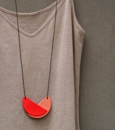 an image of a red necklace on a t - shirt that says not quite a circle handmade necklace