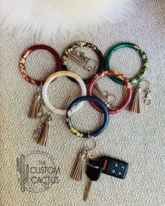 the keychains are all different colors and have tassels attached to them