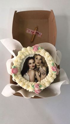 a cake in a box with two women on it