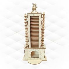 a wooden model of a tower with a clock on top