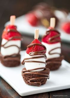 chocolate desserts with strawberries are on a white plate