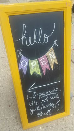 a chalkboard sign with some writing on it