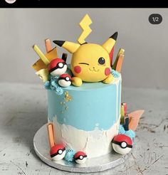 a pokemon cake with pikachu and other decorations