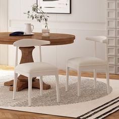 a dining room table with two chairs around it