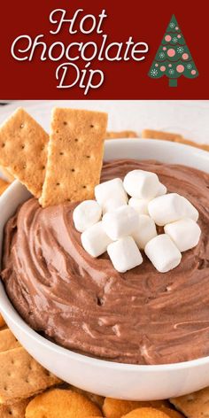 hot chocolate dip with marshmallows and graham crackers in a white bowl