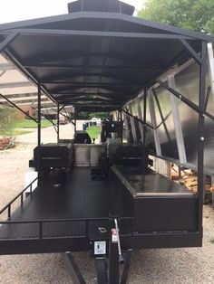 the back end of a trailer that is parked on gravel