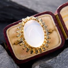 This mystical ring showcases an oval cabochon milky chalcedony stone set with delicate prongs in an openwork gallery. This chalcedony could almost be mistaken for a moonstone! The piece is crafted in 18k yellow gold and is currently a size 8.75. Antique Engagement Rings Sapphire, Estate Jewelry Rings, Wedding Ring Diamond Band, Chalcedony Stone, Chalcedony Ring, Antique Engagement Rings, Tiffany And Co, European Cut Diamonds, Sapphire Engagement