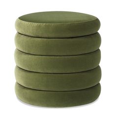 four green round cushions stacked on top of each other