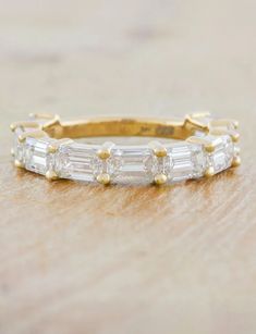 a gold band with three baguetts and four diamonds