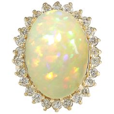 Stamped: 14K Yellow Gold Total Ring Weight: 9.2 Grams Total Natural Opal Weight is 11.28 Carat (Measures: 18.00x13.00 mm) Color: Multicolor Total Natural Diamond Weight is 1.23 Carat Color: F-G, Clarity: VS2-SI1 Face Measures: 25.30x20.45 mm Sku: [703089W] Opal Statement Ring, Opal Jewellery, Sapphire Cocktail Ring, Opal Diamond Ring, Yellow Gold Diamond Ring, Diamond Cocktail Rings, Rings Gold, Gold Diamond Ring, La Face