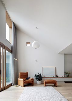 a living room filled with furniture and a large window