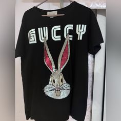 Perfect Condition Rare Gucci Designer Black T-shirt, Designer Gucci Black T-shirt, Gucci Black T-shirt With Logo Print, Black Gucci Tops With Letter Print, Gucci Black Crew Neck Top, Gucci Black Short Sleeve Tops, Black Gucci Short Sleeve T-shirt, Gucci Black Tops With Letter Print, Gucci Black Top With Letter Print