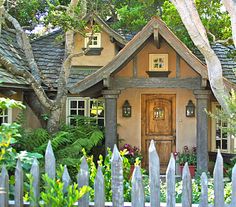 a house with a picket fence surrounding it